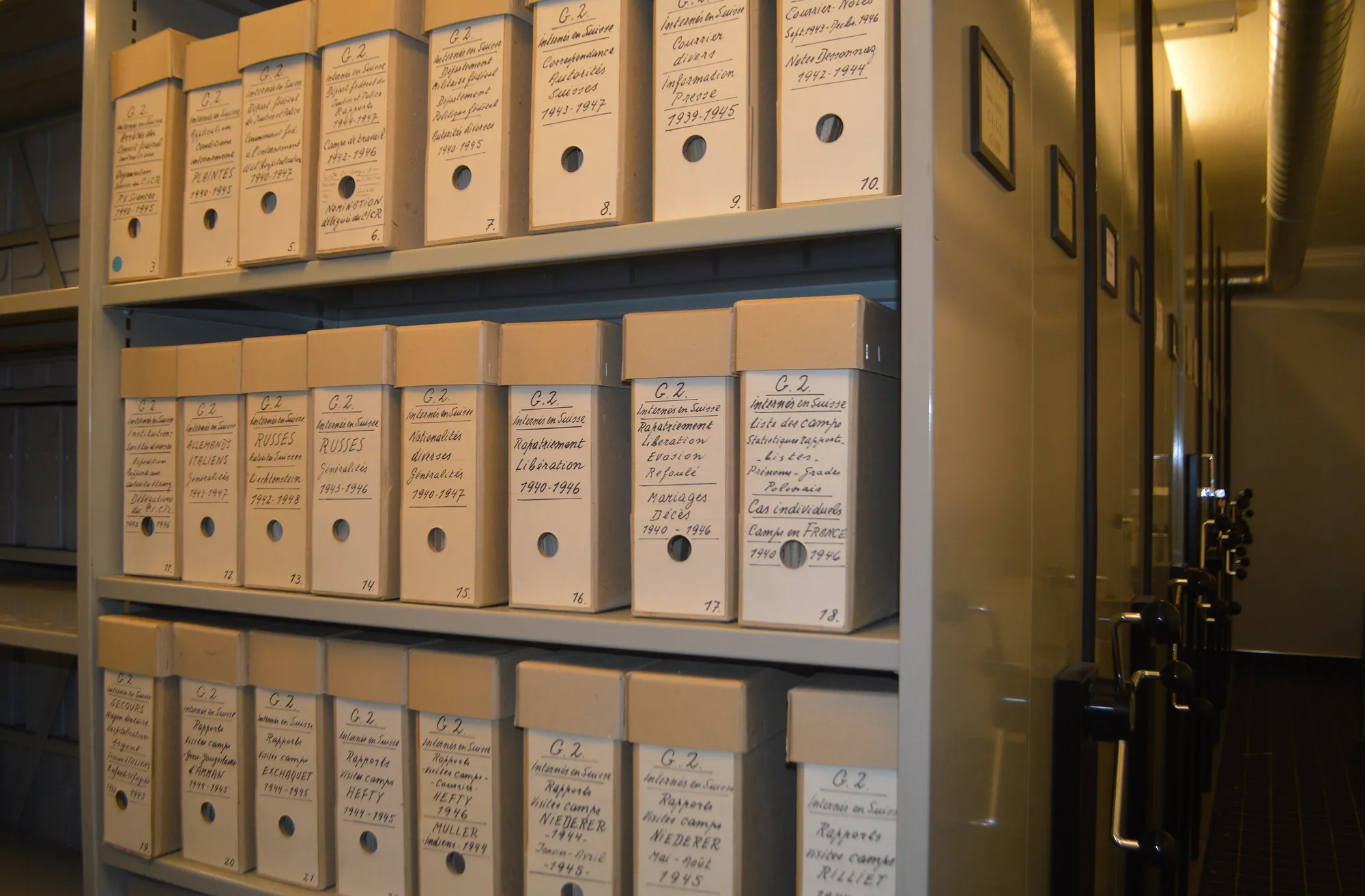 Archive shelving holding rows of labelled document boxes.